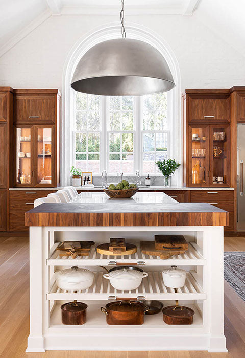 White Widows in between Wooden Kitchen Cabinets, Silver French Kitchen Ranges and Kitchen Hood