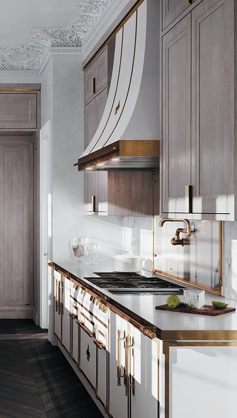 White high end kitchen ranges with golden handles and custom kitchen hood above the French stove