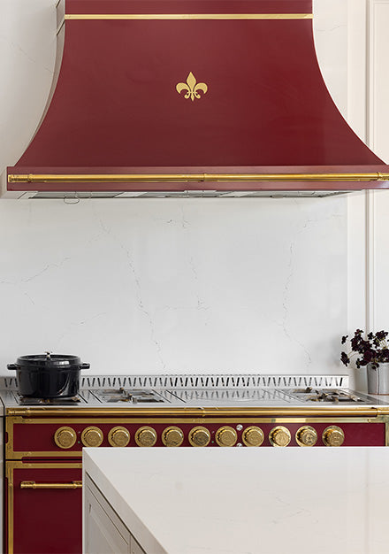 Kitchen remodeling with French Kitchen Ranges and golden french burner and red custom kitchen hood