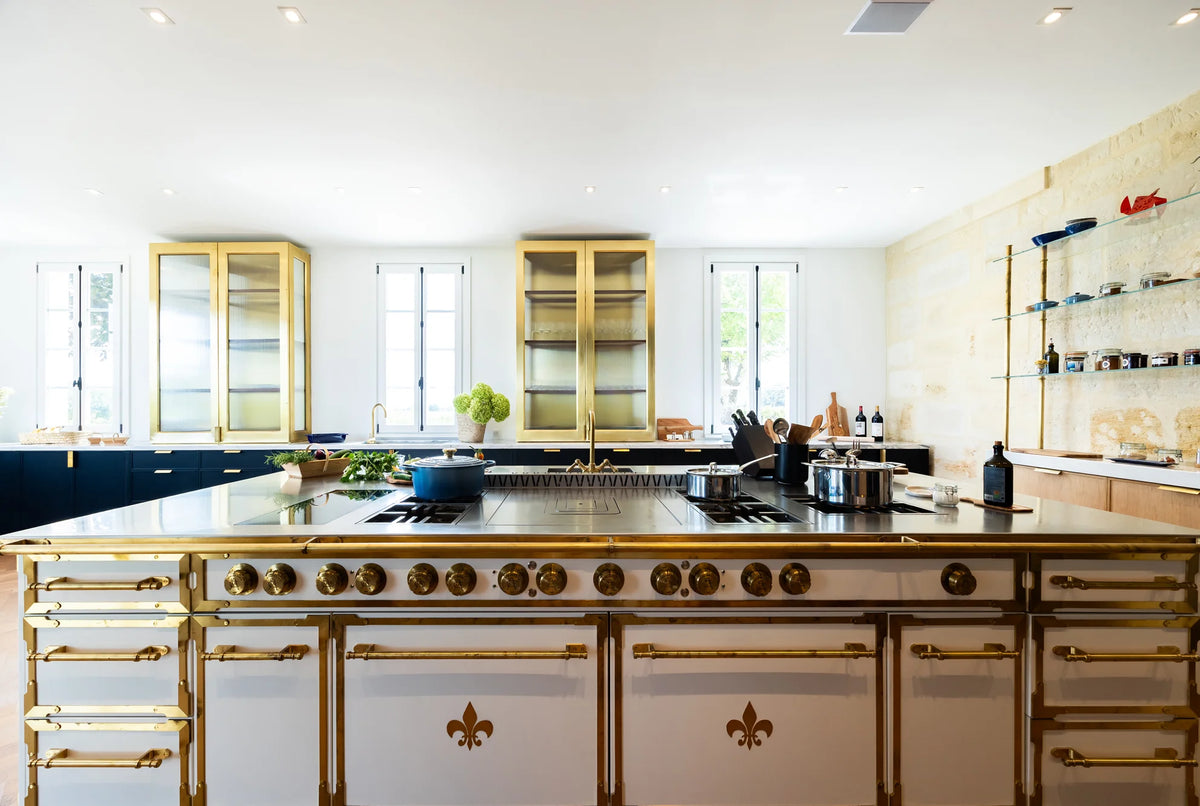 Luxury French Kitchen Range island in white with gold fleur-de-lis detailing.