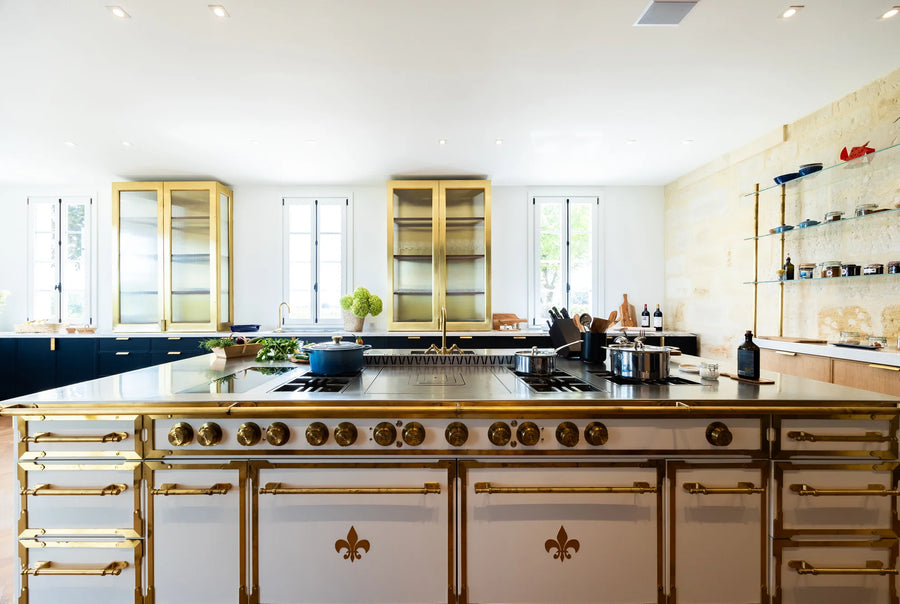 Luxury French Kitchen Range island in white with gold fleur-de-lis detailing.