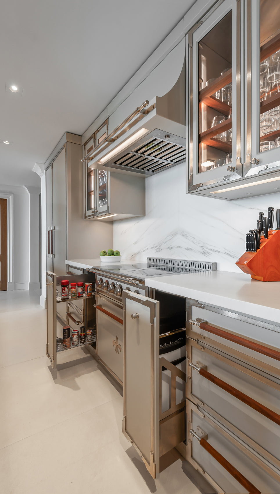 Custom kitchen pantry organization featuring integrated cabinet storage with door-mounted spice racks and pull-out shelving.