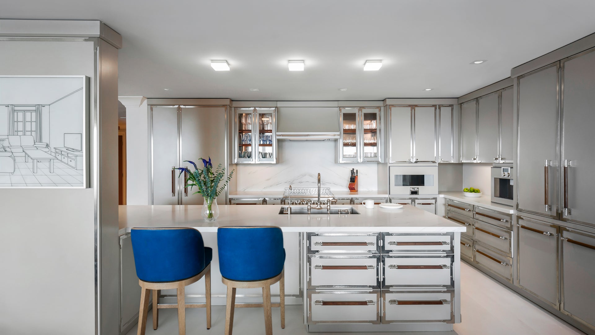 Modern kitchen island with a white quartz countertop and two vibrant blue velvet bar stools in an open-concept living space.