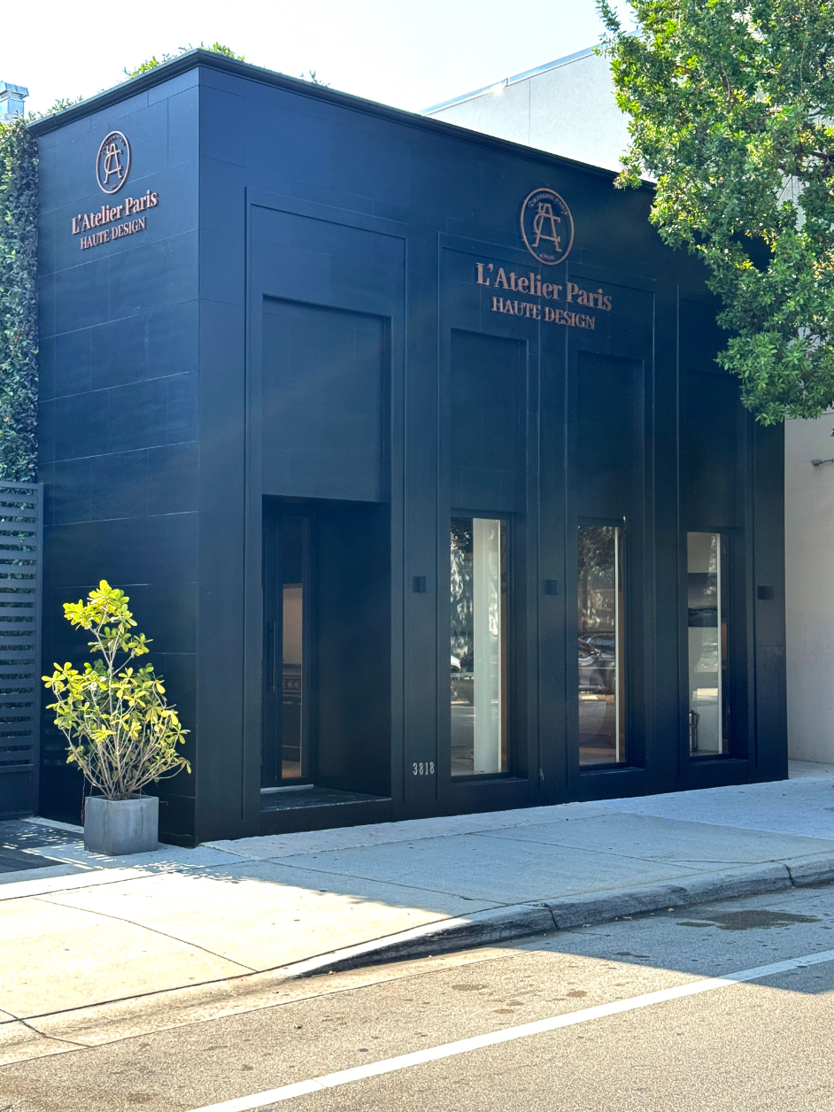 L'Atelier Paris black storefront exterior with gold signage