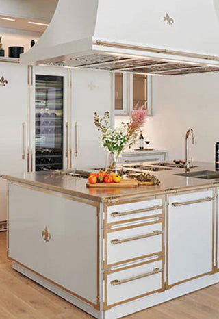 Off white French oven ranges with golden handles and golden countertop