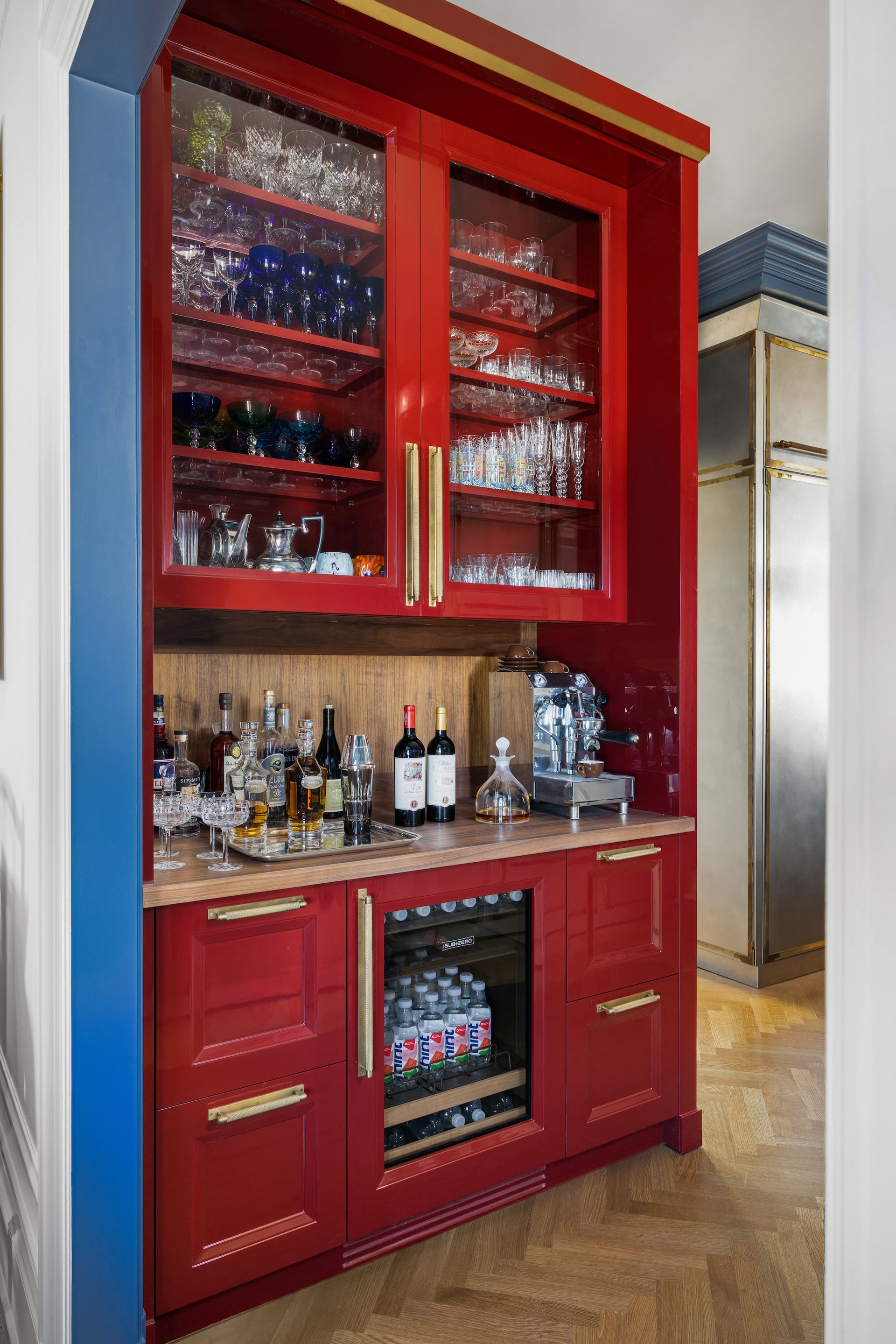 Red liquor storage cabinet with liquor bottles