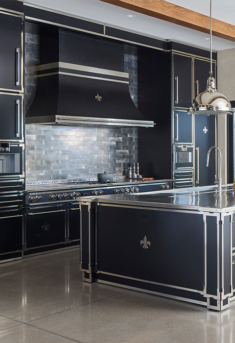 Black Kitchen Base Cabinet With Silver Handles and Countertop In the middle of the Kitchen. Black Classic Kitchen Ranges With a Hood and Black Kitchen Wall Cabinets