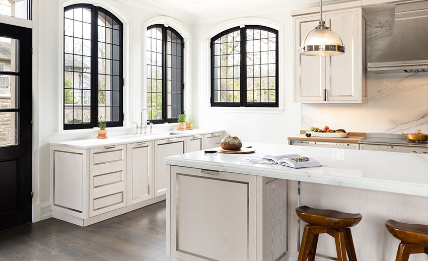 White High End Kitchen Ranges With Black Windows and a Door