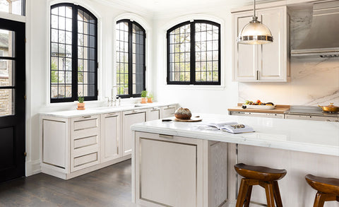 White High End Kitchen Ranges With Black Windows and a Door