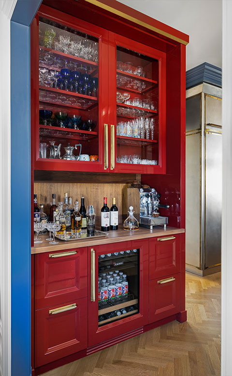Red liquor storage cabinet with liquor bottles