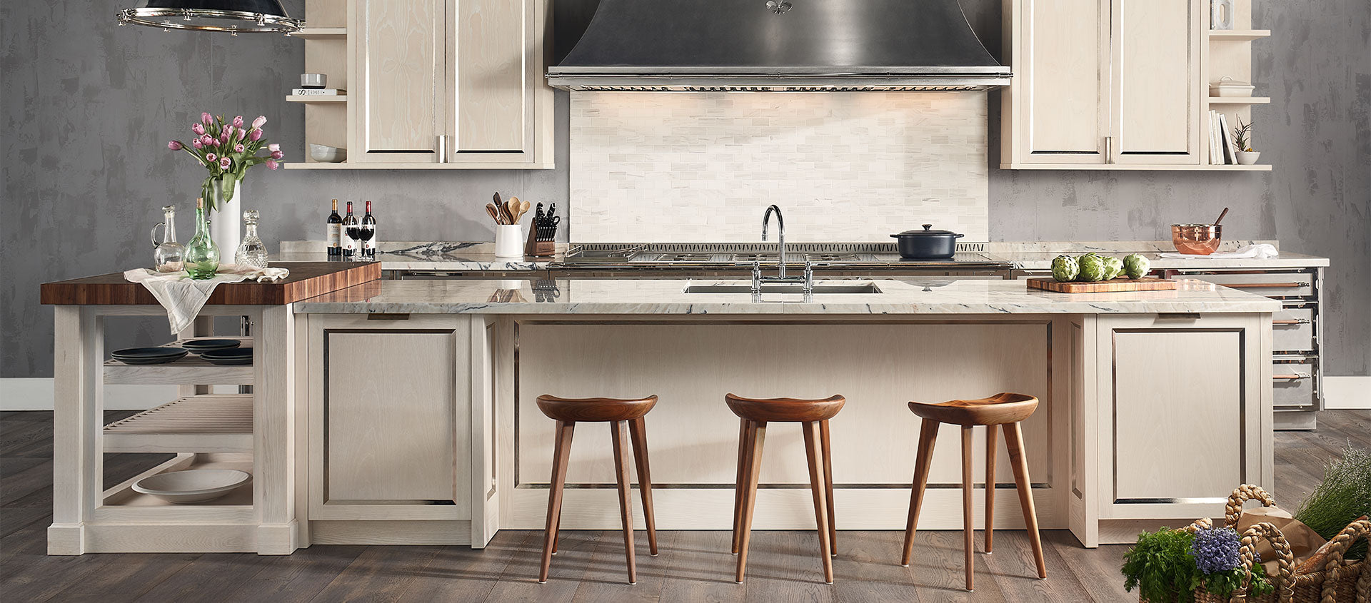 Off white kitchen cabinets and hanging cupboards, black color hood and wooden stools