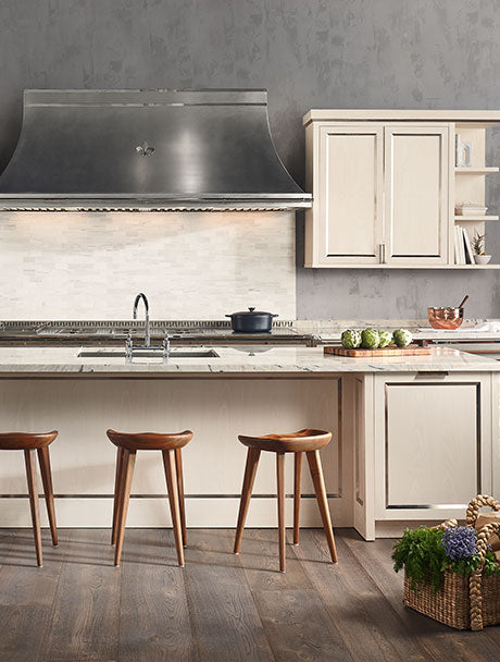 Off white kitchen cabinets and hanging cupboards, black color hood and wooden stools