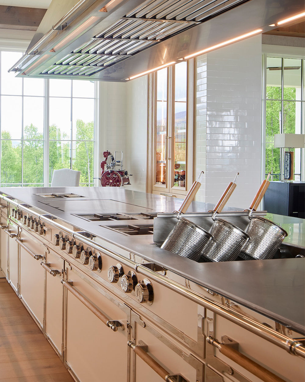 Classic French kitchen design with château-inspired inset cabinetry and a statement range