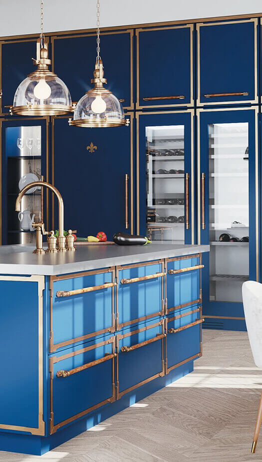 A stunning, custom blue professional range with a stainless steel cooktop and brass accents, paired with a large, dramatic matching blue range hood. The range is set against a luxurious white marble slab backsplash and a thin mosaic trim, with a brass pot filler faucet above the burners.