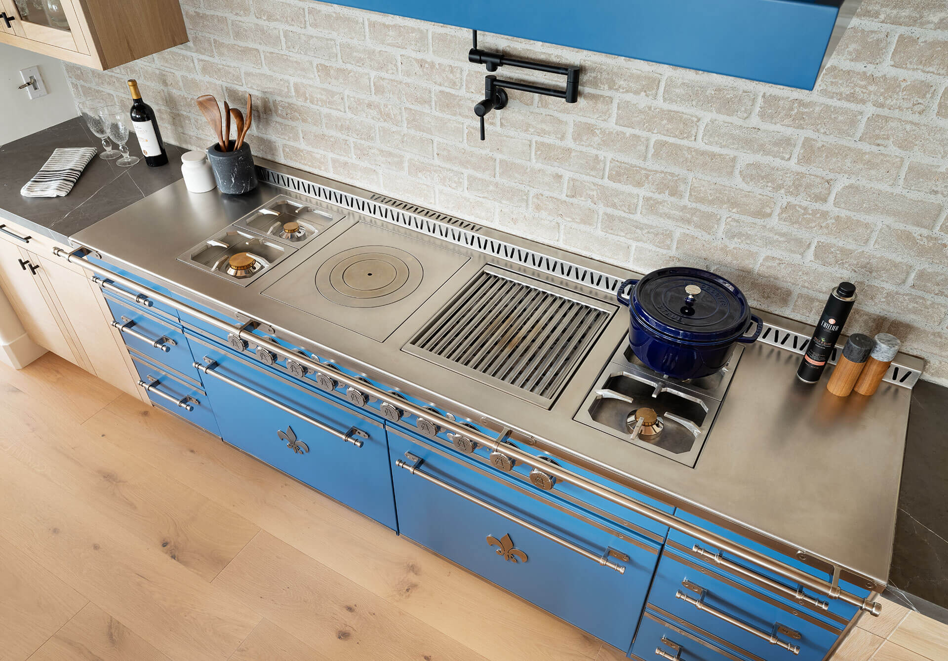 Blue high end kitchen cabinets and drawers with silver handles with high end kitchen stove