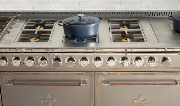 Silver Custom Kitchen Range With a Cookware on a Stove