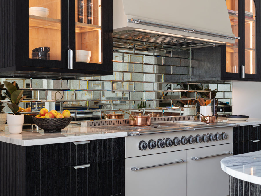 Black Kitchen Cabinets alongside of White Kitchen Oven Doors With Black Stove Burners, Off White Chimney in between two black cupboards above the kitchen range